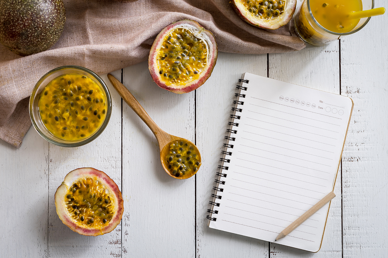 passion-fruit-and-empty-notepad-on-white-wooden-ba-2023-11-27-05-01-54-utc.jpg