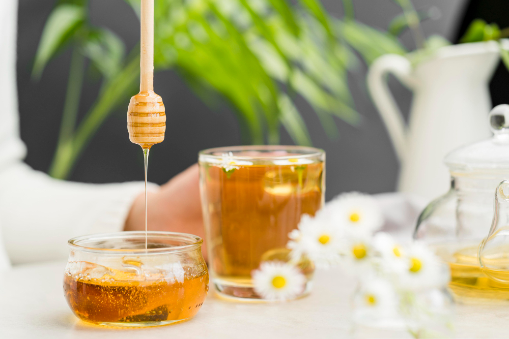 front-view-person-holding-glass-with-tea-honey-dipper.jpg